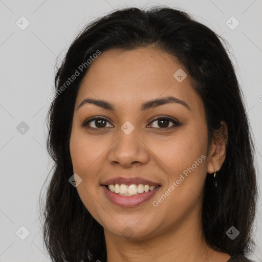 Joyful latino young-adult female with long  brown hair and brown eyes