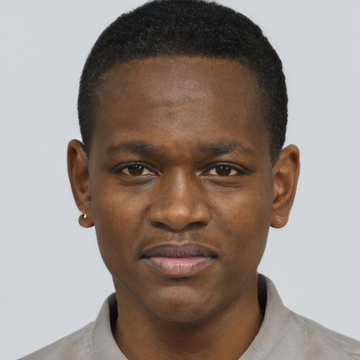 Joyful black young-adult male with short  brown hair and brown eyes