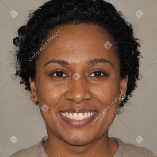 Joyful black adult female with short  brown hair and brown eyes