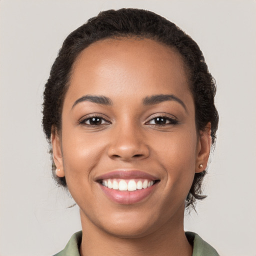 Joyful latino young-adult female with long  brown hair and brown eyes