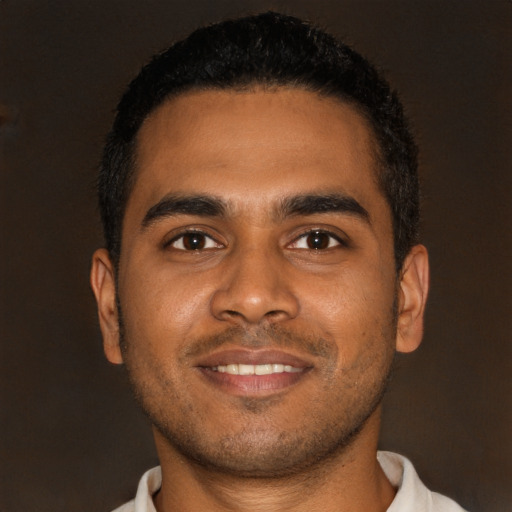 Joyful black young-adult male with short  brown hair and brown eyes