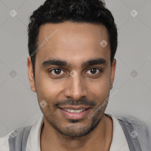 Joyful black young-adult male with short  black hair and brown eyes