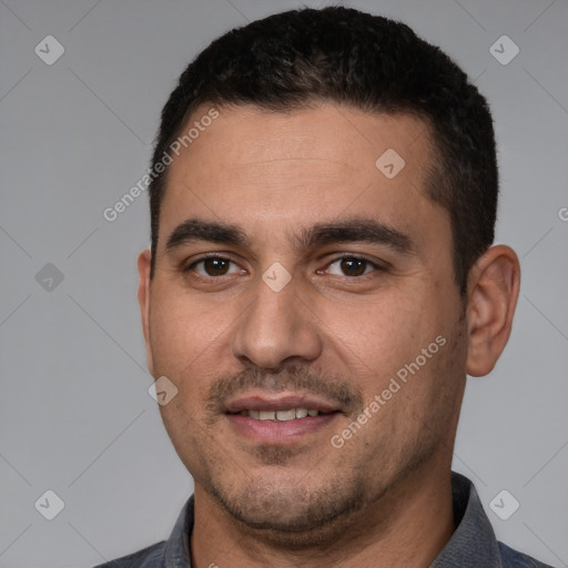 Joyful white young-adult male with short  black hair and brown eyes