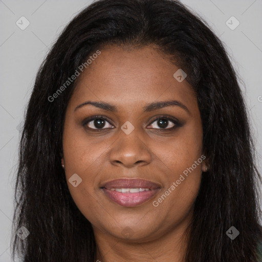 Joyful black young-adult female with long  brown hair and brown eyes