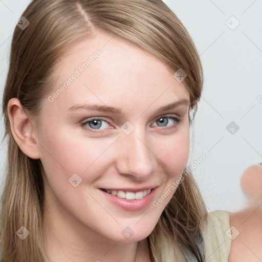 Joyful white young-adult female with long  brown hair and blue eyes