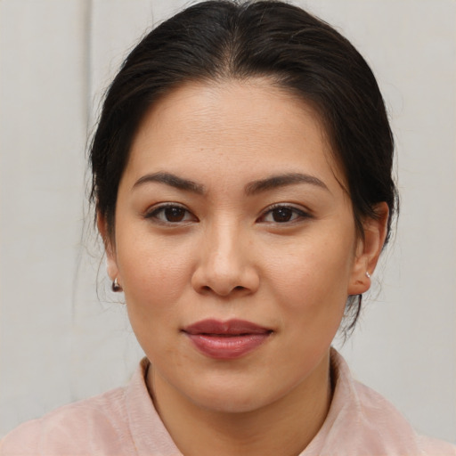 Joyful asian young-adult female with medium  brown hair and brown eyes