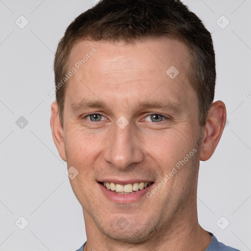 Joyful white adult male with short  brown hair and grey eyes