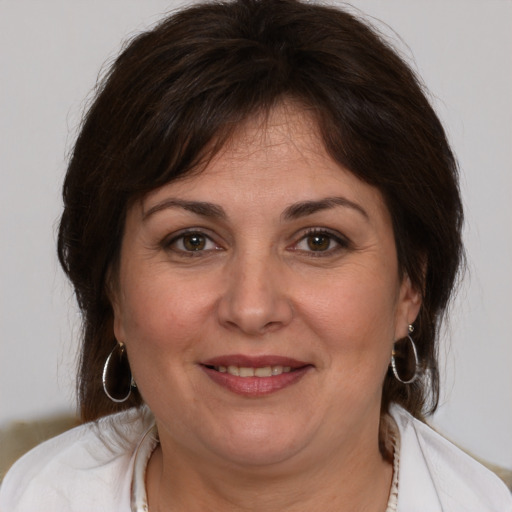 Joyful white adult female with medium  brown hair and brown eyes