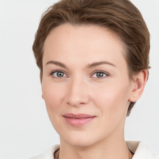 Joyful white young-adult female with short  brown hair and grey eyes