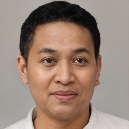 Joyful latino adult male with short  black hair and brown eyes