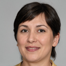 Joyful white adult female with medium  brown hair and brown eyes