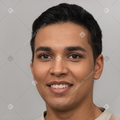 Joyful latino young-adult male with short  black hair and brown eyes