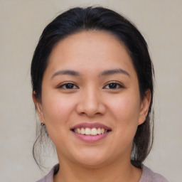 Joyful asian young-adult female with medium  brown hair and brown eyes