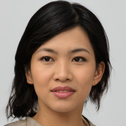 Joyful asian young-adult female with medium  black hair and brown eyes