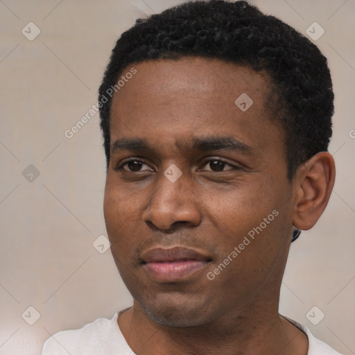 Joyful black young-adult male with short  black hair and brown eyes
