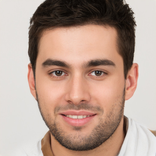 Joyful white young-adult male with short  brown hair and brown eyes