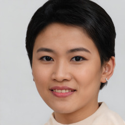 Joyful asian young-adult female with short  brown hair and brown eyes