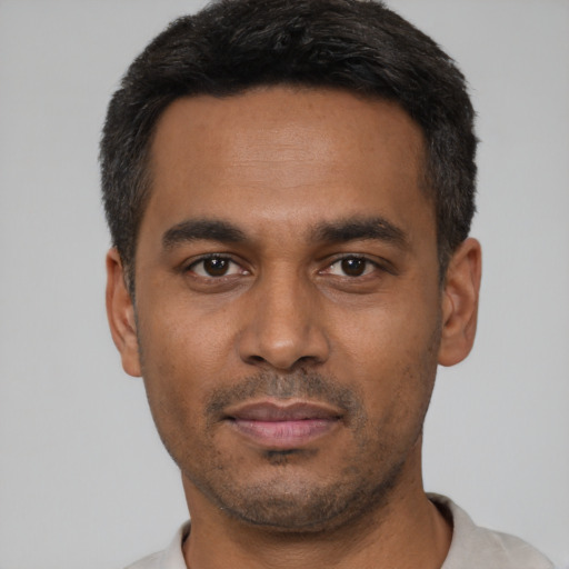 Neutral latino young-adult male with short  black hair and brown eyes