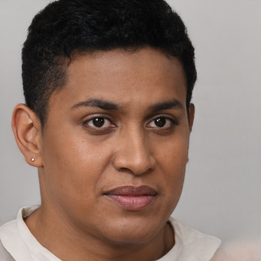 Joyful black young-adult male with short  brown hair and brown eyes