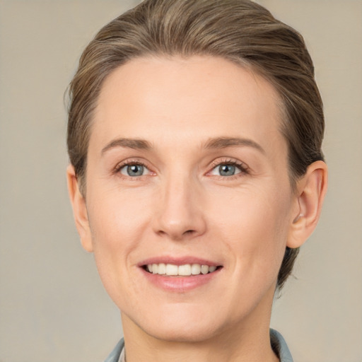 Joyful white adult female with medium  brown hair and grey eyes