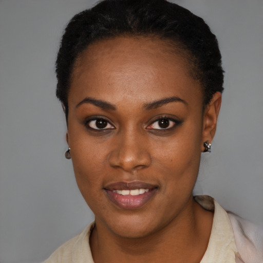 Joyful black young-adult female with short  black hair and brown eyes