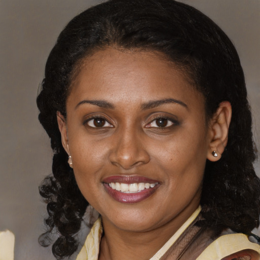 Joyful black young-adult female with medium  brown hair and brown eyes