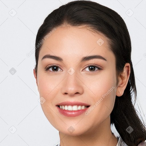 Joyful white young-adult female with long  black hair and brown eyes