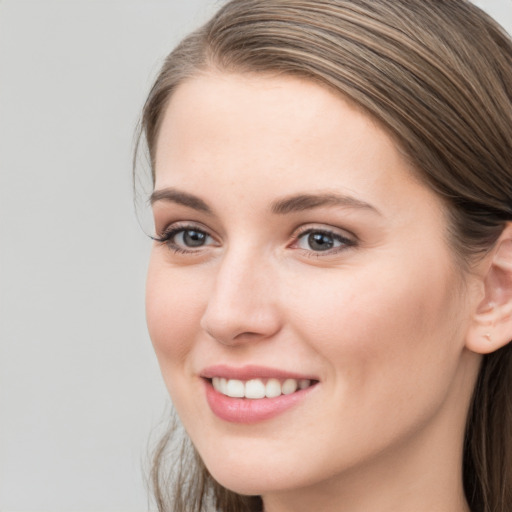 Joyful white young-adult female with long  brown hair and grey eyes