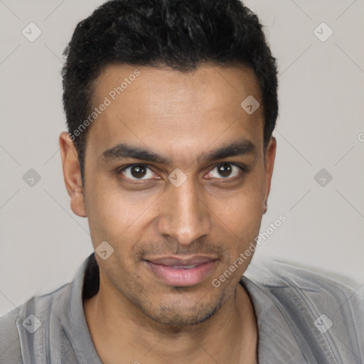 Joyful white young-adult male with short  black hair and brown eyes