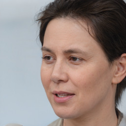 Joyful white adult female with medium  brown hair and brown eyes