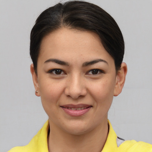 Joyful asian young-adult female with short  brown hair and brown eyes