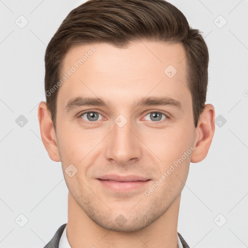 Joyful white young-adult male with short  brown hair and grey eyes