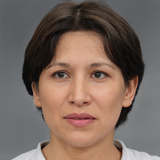 Joyful white adult female with medium  brown hair and brown eyes