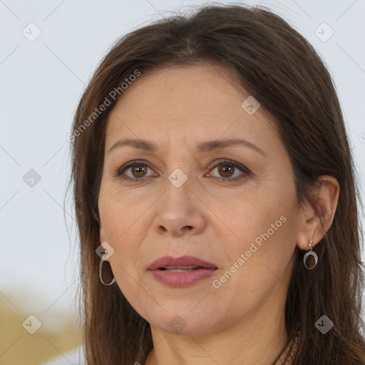 Joyful white adult female with long  brown hair and brown eyes