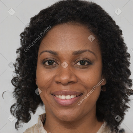 Joyful black adult female with medium  brown hair and brown eyes