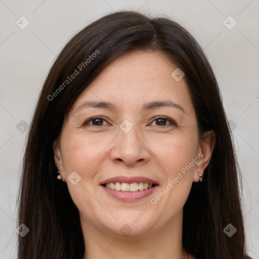 Joyful white adult female with long  brown hair and brown eyes