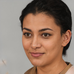 Joyful latino young-adult female with medium  brown hair and brown eyes