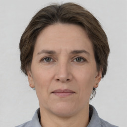 Joyful white adult female with short  brown hair and grey eyes