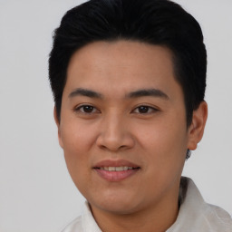 Joyful asian young-adult male with short  black hair and brown eyes