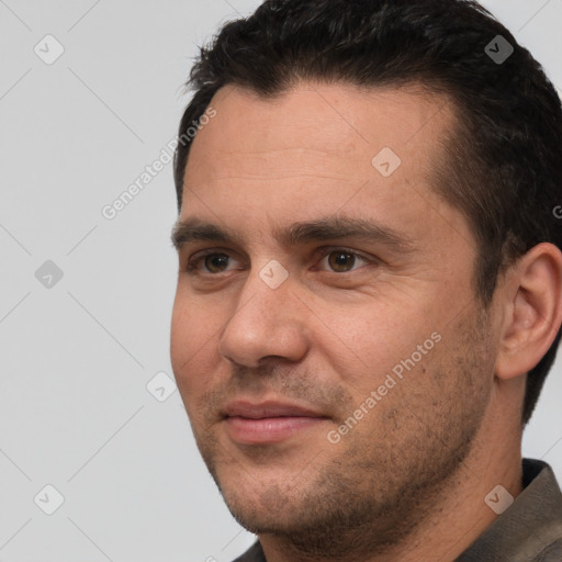 Joyful white adult male with short  brown hair and brown eyes