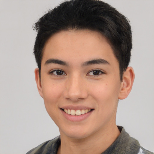 Joyful asian young-adult male with short  black hair and brown eyes