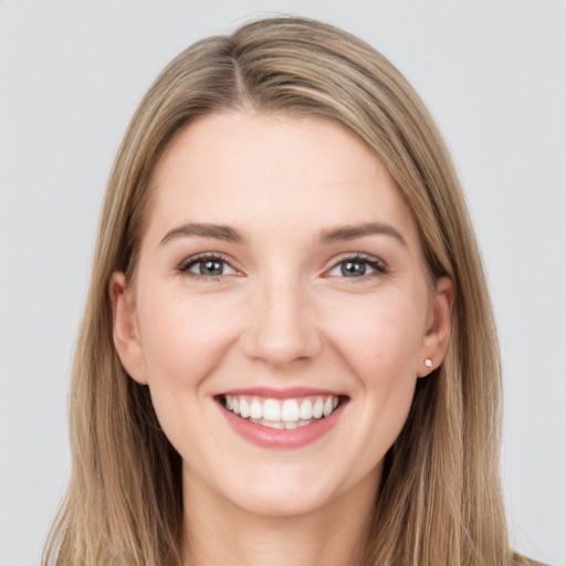 Joyful white young-adult female with long  brown hair and grey eyes