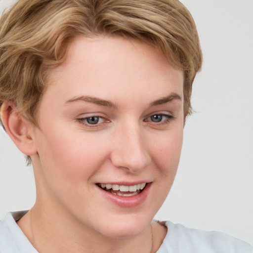 Joyful white young-adult female with short  brown hair and blue eyes