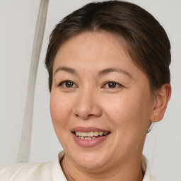 Joyful white adult female with short  brown hair and brown eyes