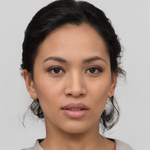 Joyful latino young-adult female with medium  black hair and brown eyes