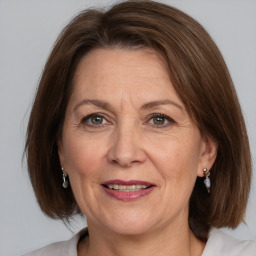 Joyful white adult female with medium  brown hair and grey eyes