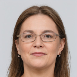 Joyful white adult female with long  brown hair and grey eyes