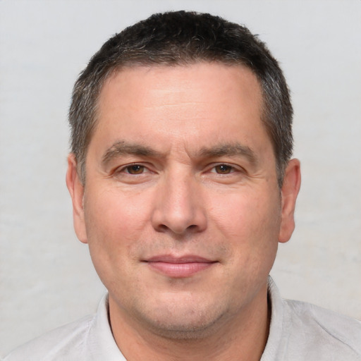 Joyful white adult male with short  brown hair and brown eyes