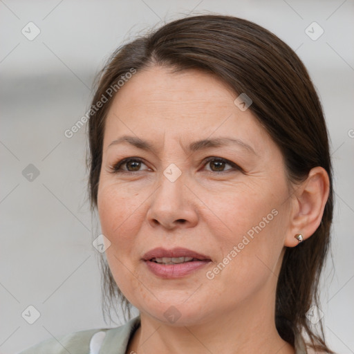 Joyful white adult female with medium  brown hair and brown eyes