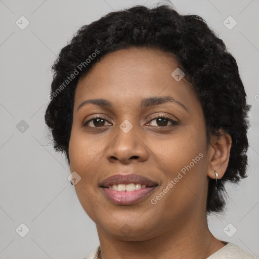 Joyful black young-adult female with short  brown hair and brown eyes